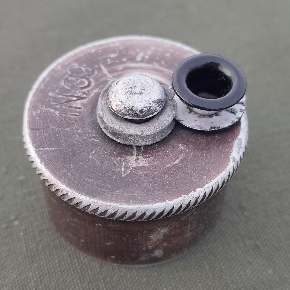 Aluminum grommet for field bottle cap