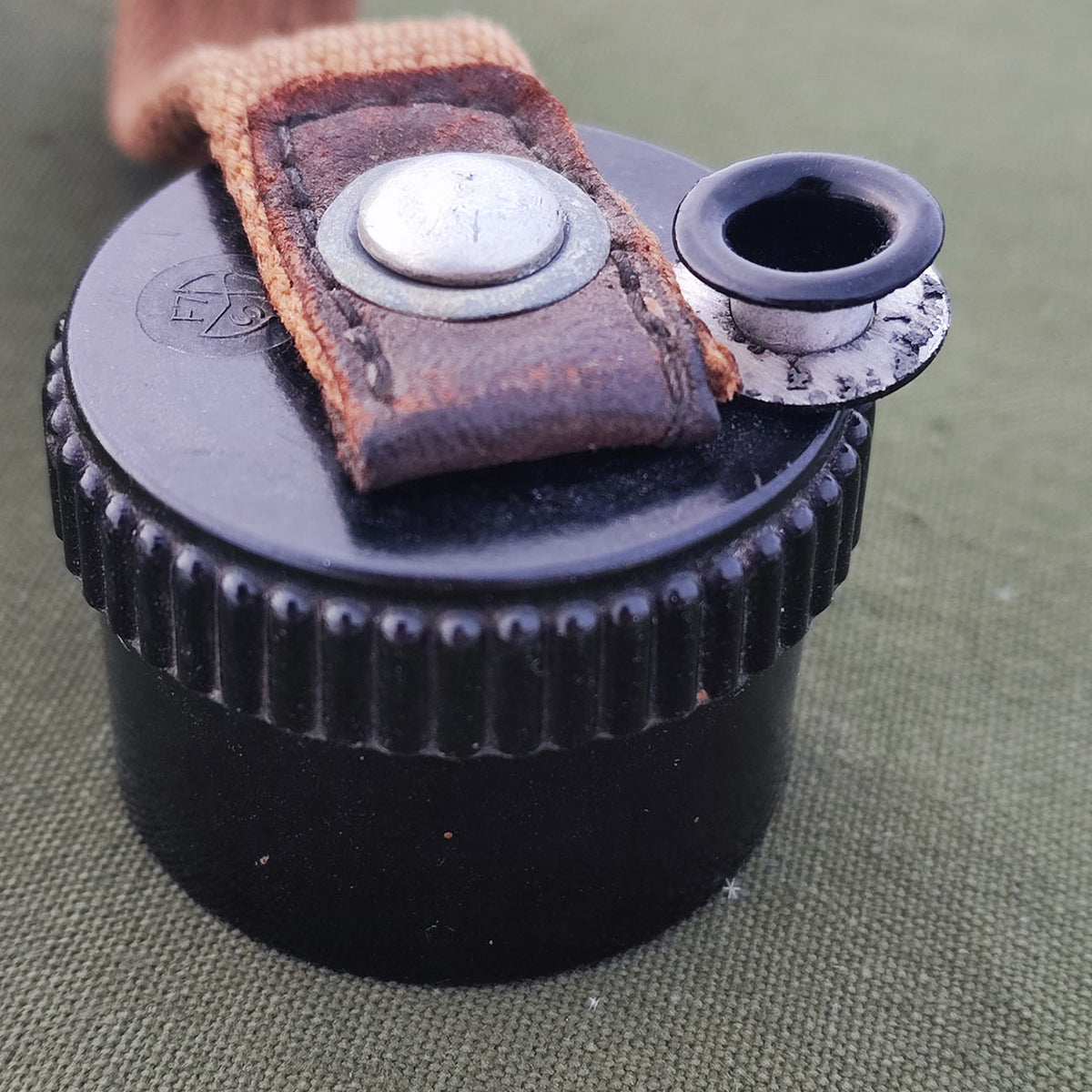 Aluminum grommet for field bottle cap