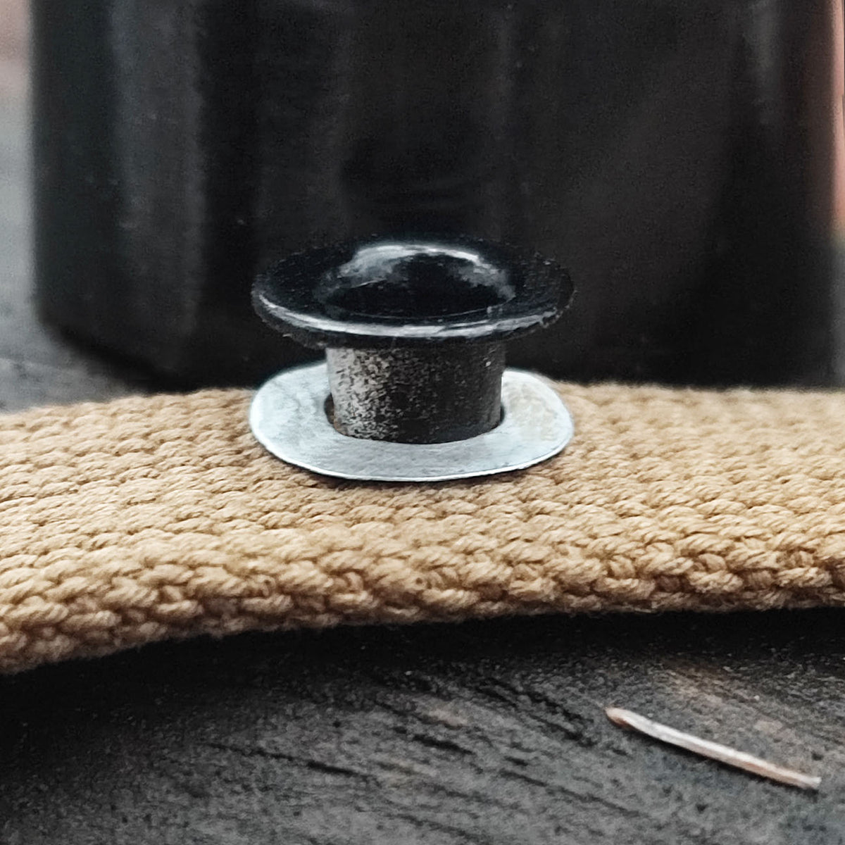 Aluminum grommet for field bottle cap